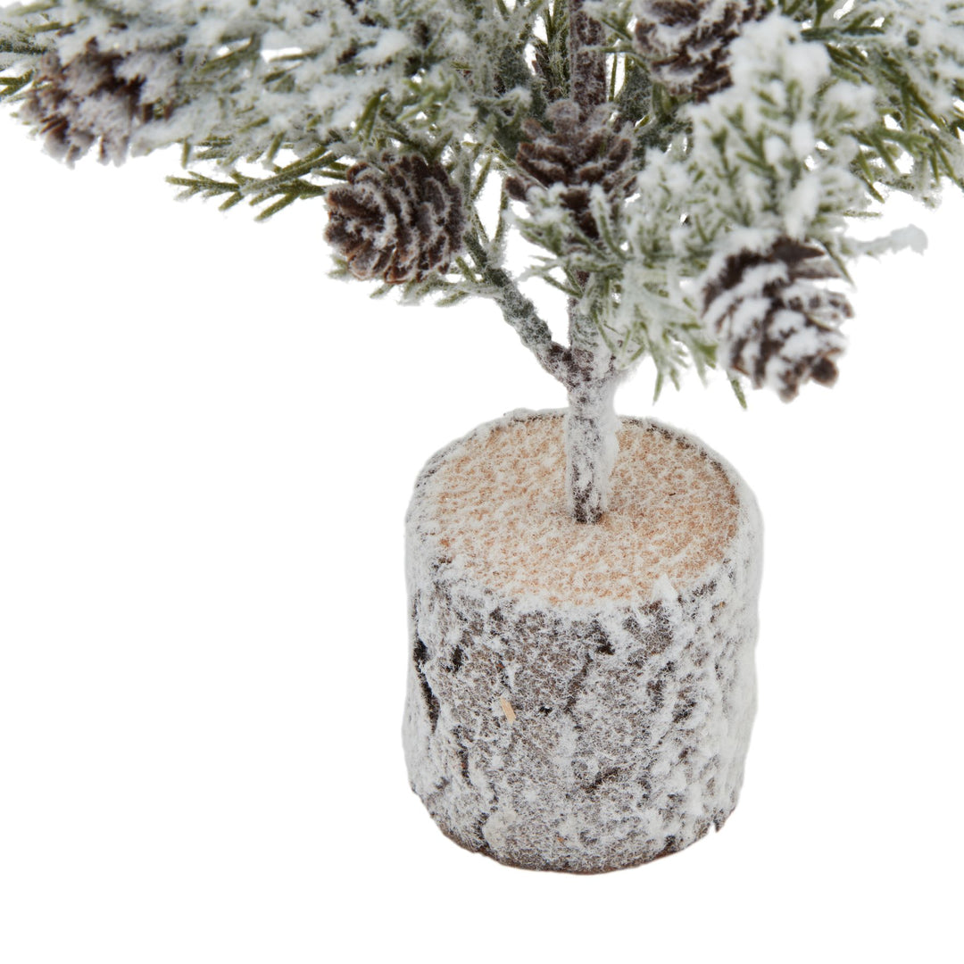 Small-Snowy-Fir-Tree-With-Pinecones-In-Wood-Log